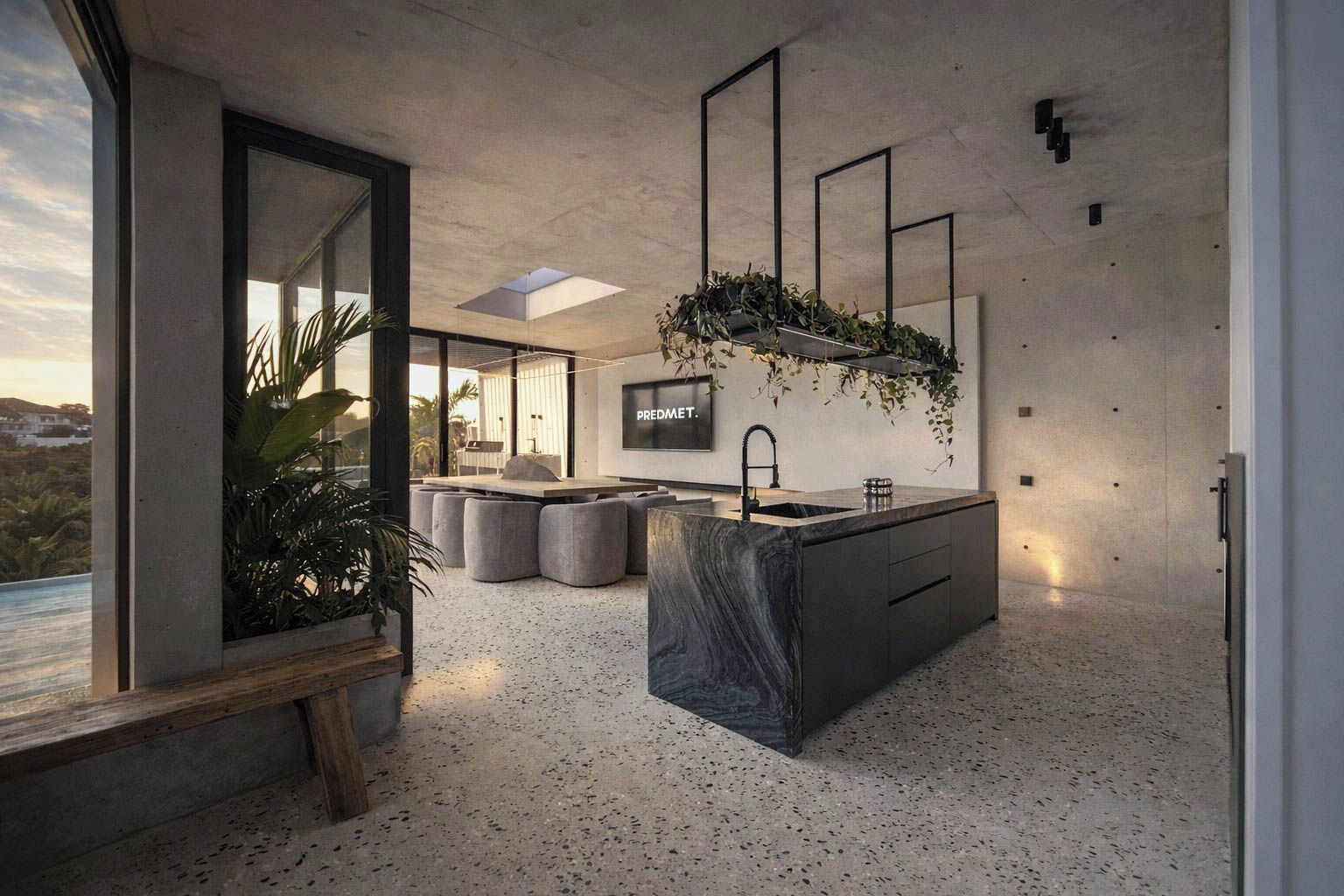 A modern kitchen with a large island, seating area, and a view of the outdoors.