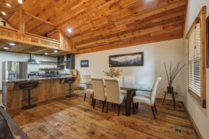 A wooden interior with a kitchen, dining area, and a high ceiling. - Dual Blue Ridge Cabins, sleeps 14, large yard, dogs welcome! (Blue Ridge)