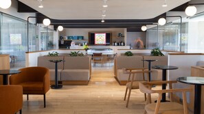A modern cafe with a central counter, seating areas, and a kitchen in the background. - Casa Myla a pasos de Polanco y Reforma (Mexico City)