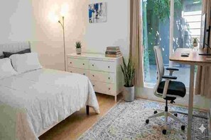 A bedroom with a bed, a dresser, a desk with a chair, and a window with curtains. - High-quality Condo Type: Studio City & quintessential Los Angeles lifestyle. (Studio City)