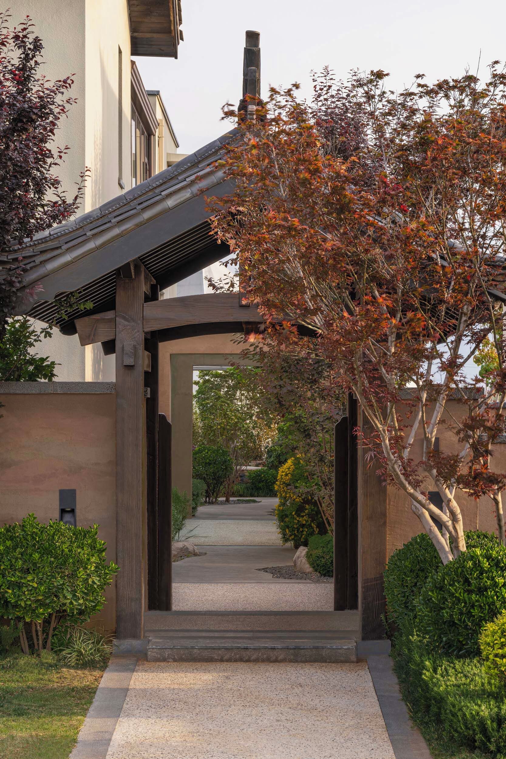 A pathway leading to a building with a traditional wooden structure.