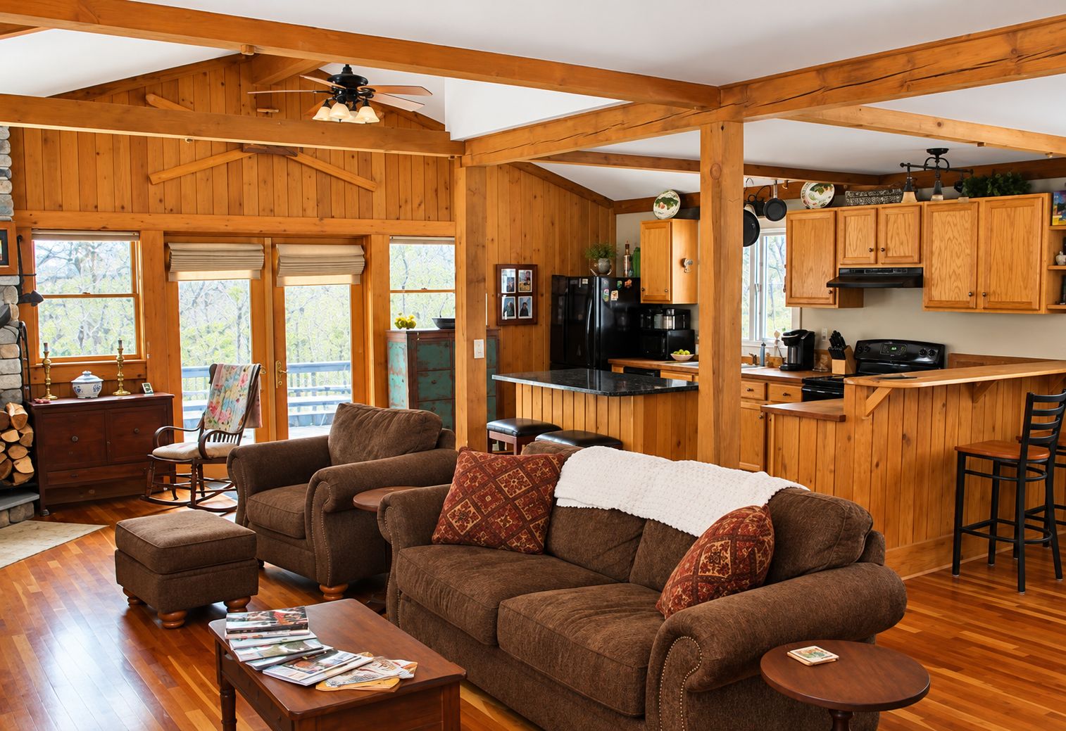 A cozy cabin interior with a living room, kitchen, and dining area.