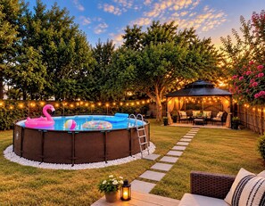An outdoor swimming pool with a hot tub, surrounded by a deck with outdoor furniture, string lights, and a gazebo. - Cedar Park Oasis - Pool, Movie & Game Room, BBQ, Sleeps 18 (Cedar Park)