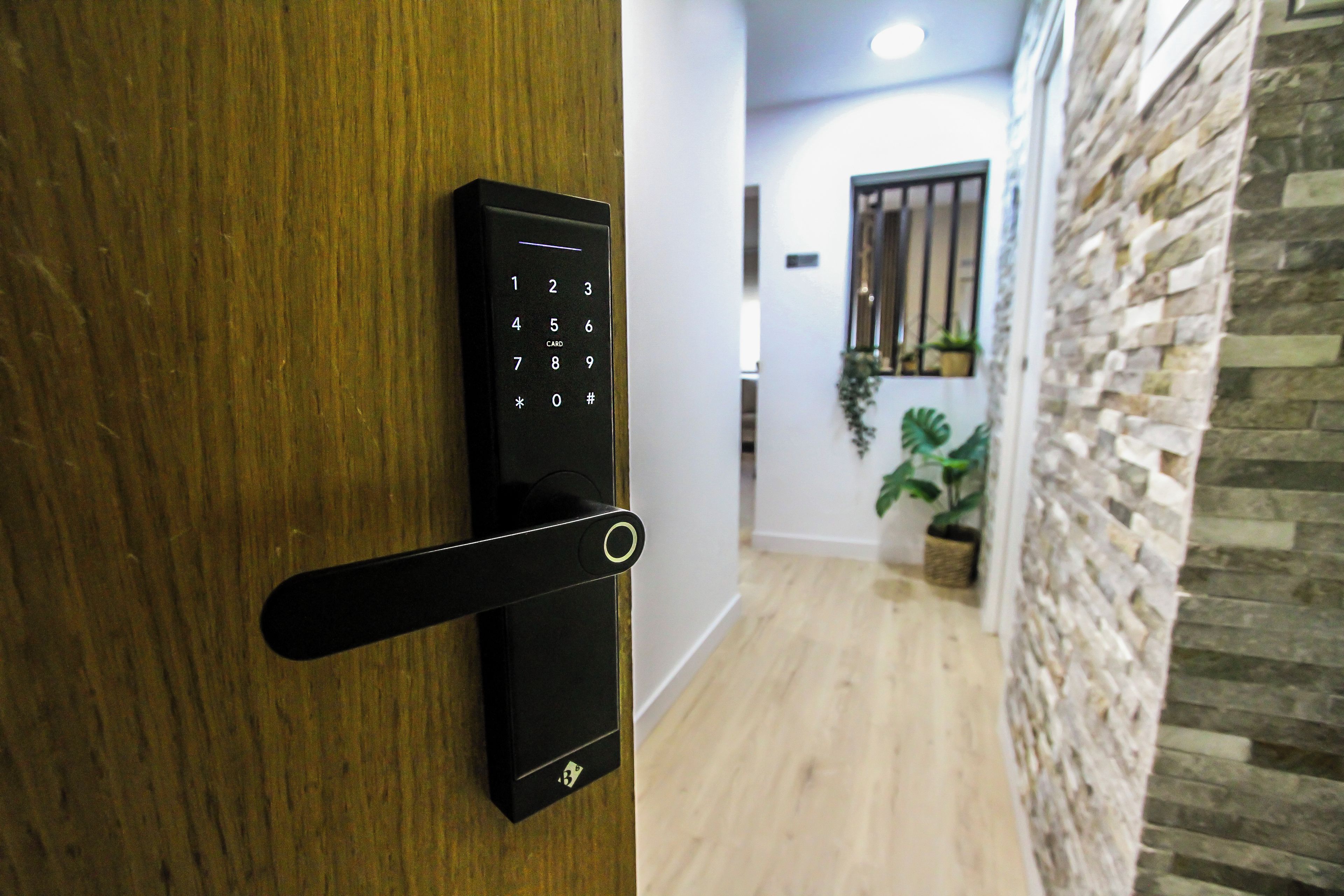A modern door with a keypad lock and a card reader.