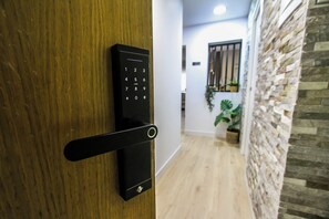 A modern door with a keypad lock and a card reader. - Terrific 3-bedroom apartment in the heart of Pamplona (Pamplona)