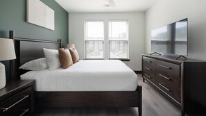 A bedroom with a bed, nightstands, a dresser, and a TV. - Landing | Chic 1BD - One Bedroom Apartment, Sleeps 2 (Nashville)