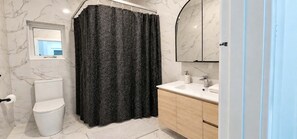 A bathroom with a toilet, a sink, a mirror, and a shower curtain. - Park-view private rooms in a house in Clovelly Park, Adelaide, South Australia! (Clovelly Park)
