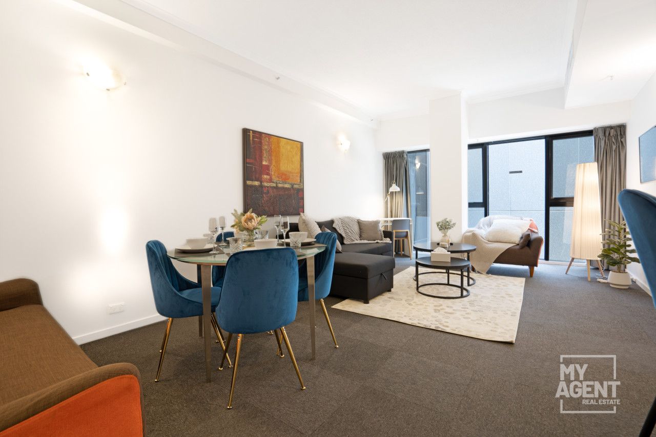 A modern living room with a dining area, a sofa, a coffee table, and a large window with curtains.