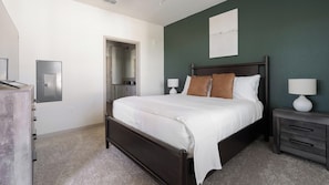 A bedroom with a bed, bedside tables, a wardrobe, and a door leading to a bathroom. - Landing | Chic 1BD, Clubhouse, Gym (Port Charlotte)