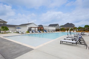 A swimming pool with lounge chairs and umbrellas, surrounded by buildings with a modern design. - Landing | Beautiful 2BD, Clubhouse, Game Room (Huntsville)