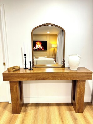 A wooden console table with a mirror, candles, and a vase. - Golf Car Fun ,Spring & Swing Retreat (Altamonte Springs)