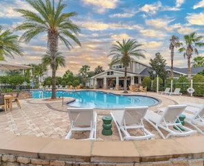 A swimming pool with lounge chairs and palm trees. - Landing | Stunning 1BD, Clubhouse, Gym (Jacksonville)