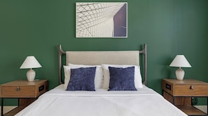A neatly made bed with two pillows, a headboard, and two bedside tables with lamps. - Landing | Incredible 1BD, Rooftop Lounge (Fort Worth)