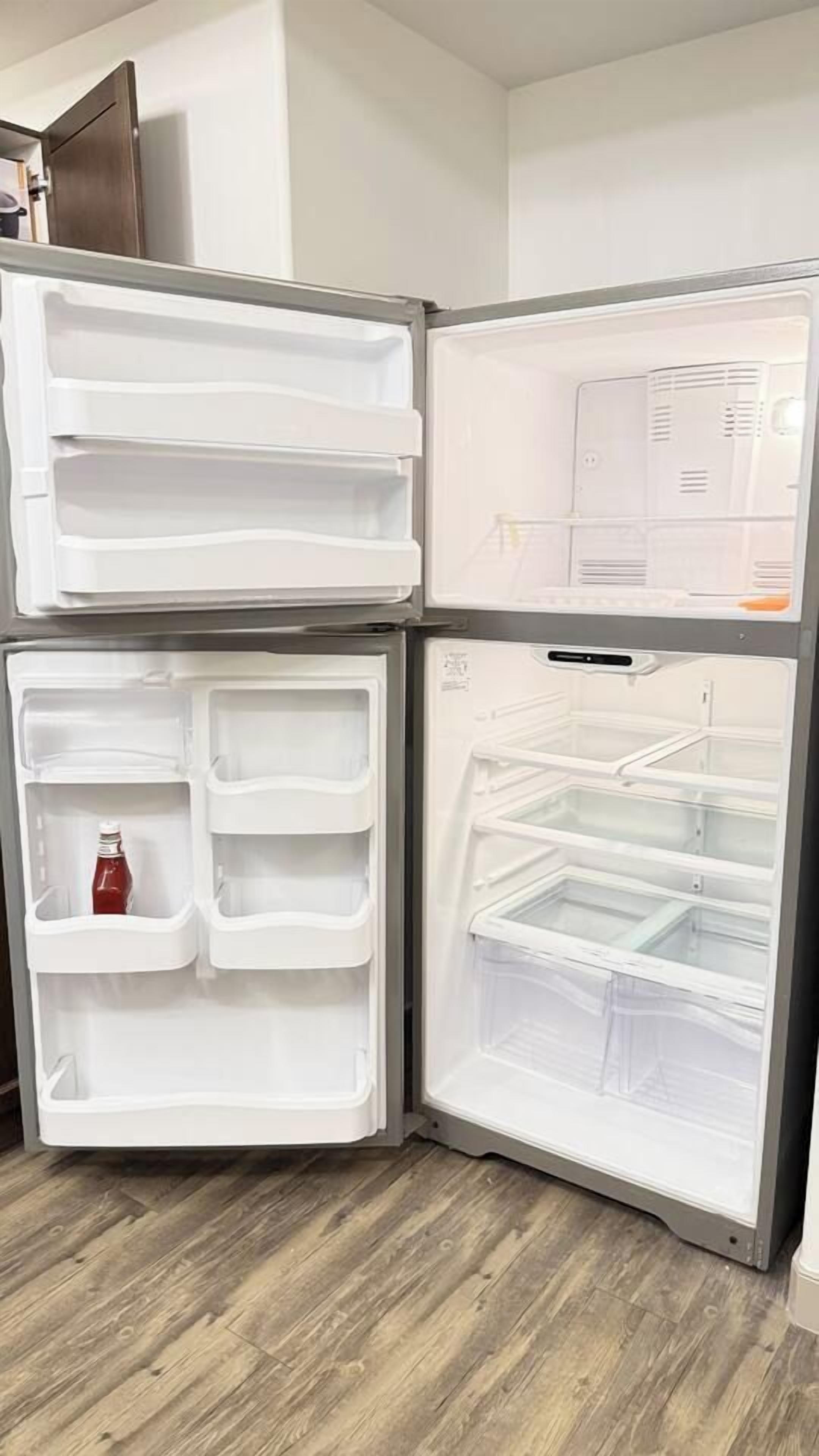 A modern kitchen with a built-in refrigerator and a microwave.