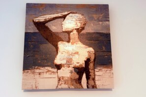 A painting of a figure with a hat, set against a blue background. - Savanna Breeze | Modern 3BR | Near YYC Airport (Calgary)