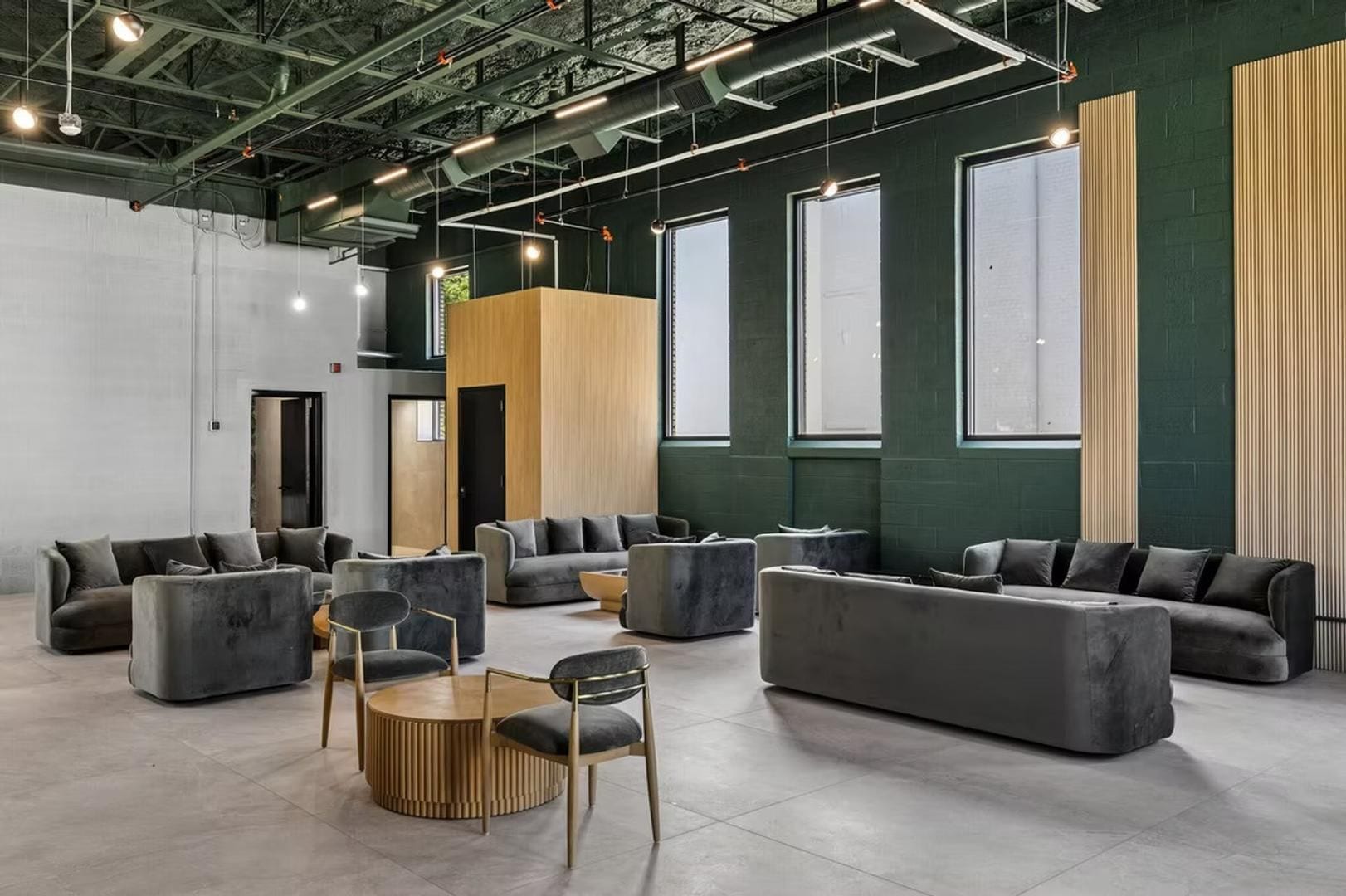 A modern lounge area with sofas, chairs, and a coffee table.