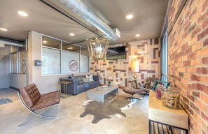 A modern living room with a sofa, armchairs, a coffee table, and a fireplace. - Landing | Beautiful 1BD, Gym (College Station)