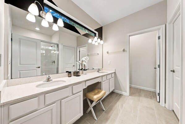 A modern bathroom with two sinks, a large mirror, and a vanity with storage. - Theater Area | Games Area | Private Pool (Davenport)
