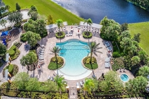 A resort with a central swimming pool, sun loungers, and palm trees. - Theater Area | Games Area | Private Pool (Davenport)