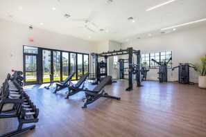 A gym with weightlifting equipment, benches, and cardio machines. - Landing | Modern 1BD in East Naples (Naples)