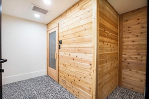 A room with wooden panel walls, a door with a glass panel, and a tiled floor. - Landing | Amazing 1BD in East Naples (Naples)