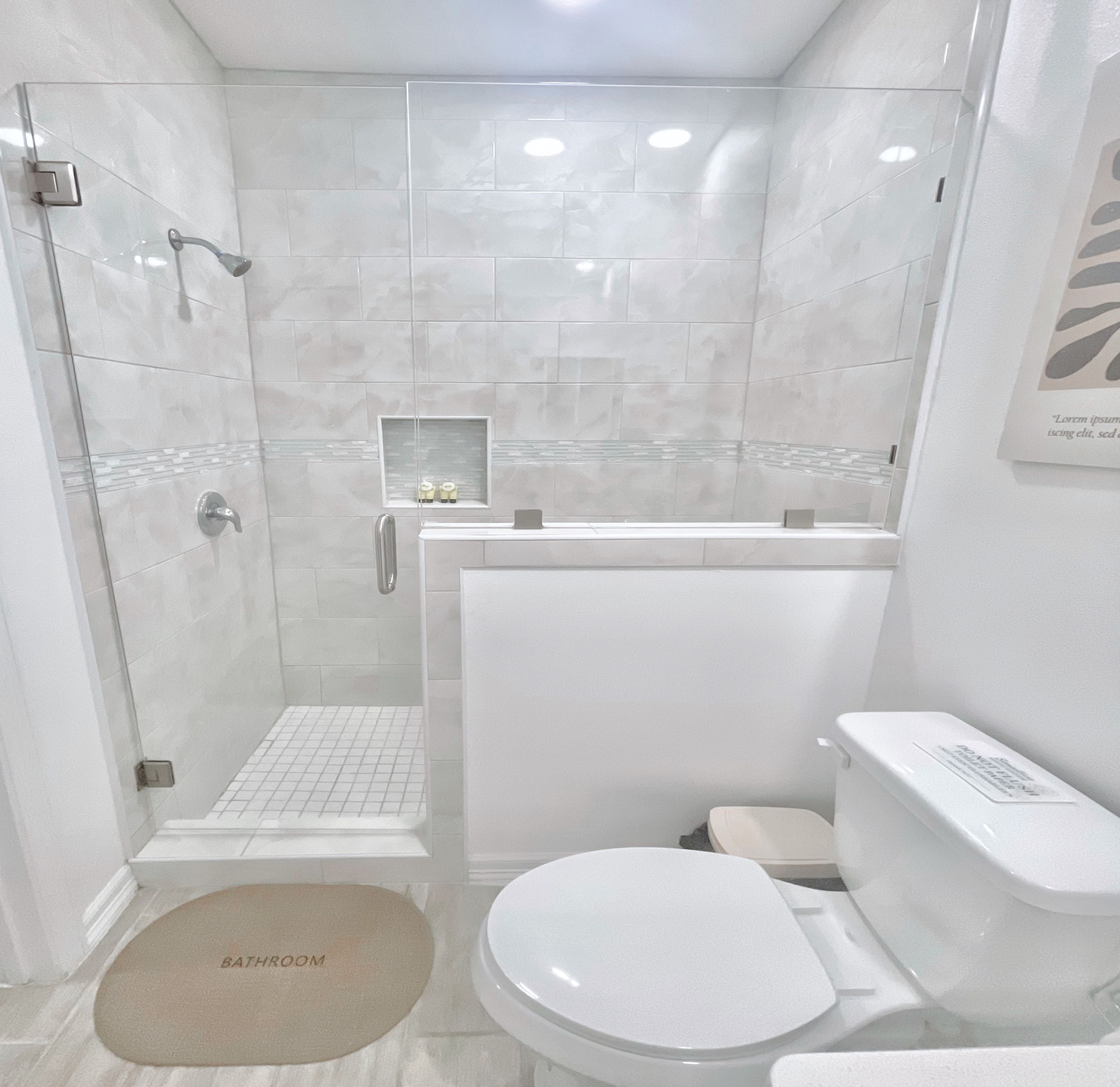 Une salle de bain moderne avec une douche à parois de verre, des toilettes blanches et un bidet.