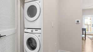 A laundry room with two stacked washing machines and a dryer. - Landing | Incredible 1BD in Loughman (Davenport)