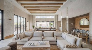 A spacious living area with a large sectional sofa, a coffee table, and a pool table. - Landing | Stylish 2BD in Loughman (Davenport)