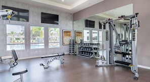 A gym with exercise equipment, a bench, and a rack of dumbbells. - Landing | Stylish 2BD in Loughman (Davenport)