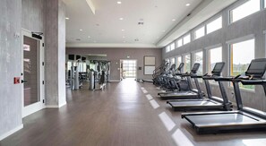 A gym with treadmills, weight machines, and a large windowed wall. - Landing | Incredible 2BD in Loughman (Davenport)