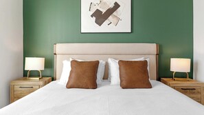 A neatly made bed with two pillows, a headboard, and two bedside tables with lamps. - Landing | Amazing 2BD in North Kissimmee (Kissimmee)
