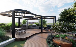 An outdoor patio with a curved wooden deck, seating arrangements, and a pergola structure. - Landing | Spectacular 1BD, Gym (Birmingham)