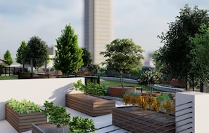 A rooftop garden with various planters and trees. - Landing | Amazing 1BD, Gym (Birmingham)