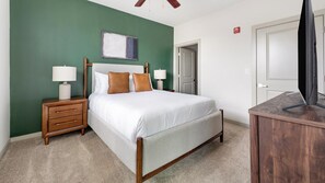 A bedroom with a bed, nightstands, a desk, and a television. - Landing | Stunning 2BD, Gym (Birmingham)