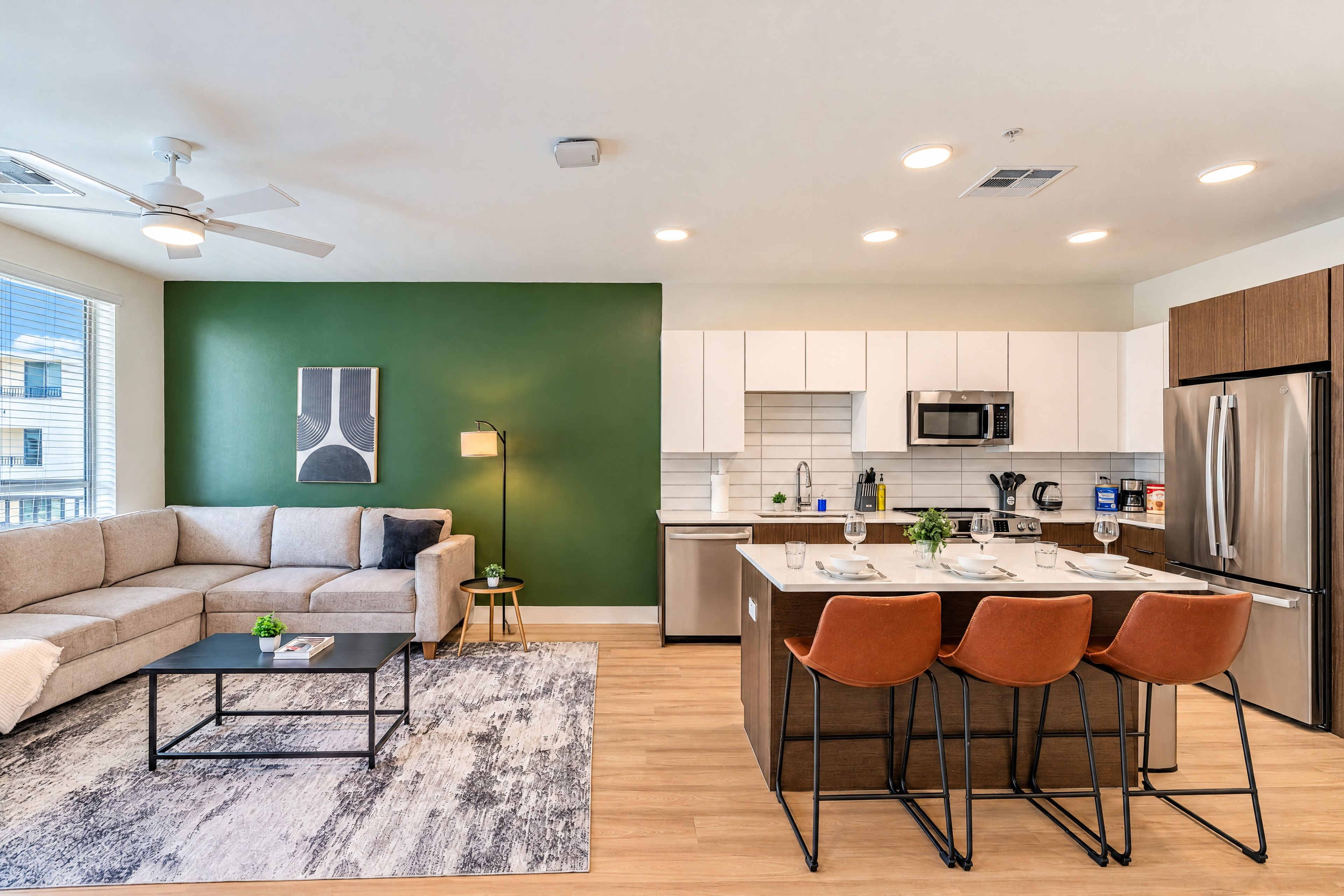 A modern apartment with a living room, kitchen, and dining area.