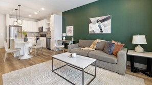 A modern living space with a kitchen, dining area, and a sofa set. - Landing | Incredible 1BD in Whitestone (Fort Worth)