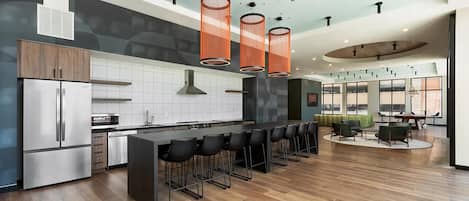 Una cocina moderna con una isla central, taburetes de bar e iluminación colgante.