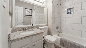 A bathroom with a sink, toilet, and bathtub. - Landing | Stunning 1BD, Pool, Yoga Studio (Green Bay)