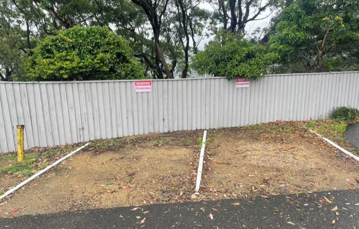 A fenced area with two signs indicating 'RESERVED' and 'OCEANVIEW'.