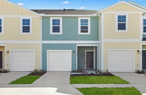A row of townhouses with two-story garages and a central entrance. - Landing | Spectacular 3BD, Pool, Clubhouse (Jacksonville)