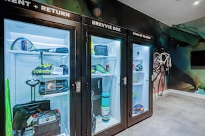 Three refrigerated storage units labeled 'BREVIE BOX' with QR codes for opening. - Landing | Spectacular 2BD, Pool (Tampa)