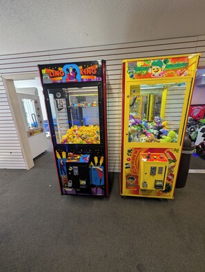 Two claw machines with colorful designs and various prizes inside. - Oceanview-Corner Condo-2 Private Balconies-Hot Tubs, Heated Pools, Lazy Rivers. (Myrtle Beach)