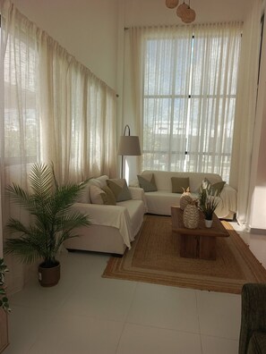 A living room with a sofa set, a coffee table, and a lamp. - Paradise Private Pool Villa (Punta Cana)