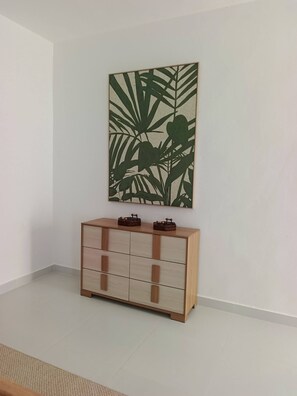 A room with a wooden cabinet and a large wall art piece. - Paradise Private Pool Villa (Punta Cana)
