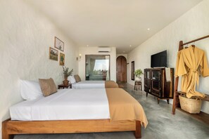 A hotel room with two beds, a television, a wardrobe, and a view of the outdoors. - Hidden 5BR Pool Villa - 8' Walk to An Bang Beach (Đà Nẵng)