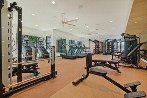 A gym with treadmills, weight machines, and free weights. - Landing | Chic 1BD in North Burnet (Austin)