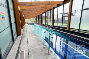 An indoor swimming pool with a wooden ceiling and large windows. - 2 Bedroom near Crown, Sleeps 6 (Southbank)