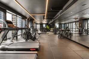 A modern gym with treadmills, stationary bikes, and free weights. - Luxury Southbank Skyline Stay (Southbank)
