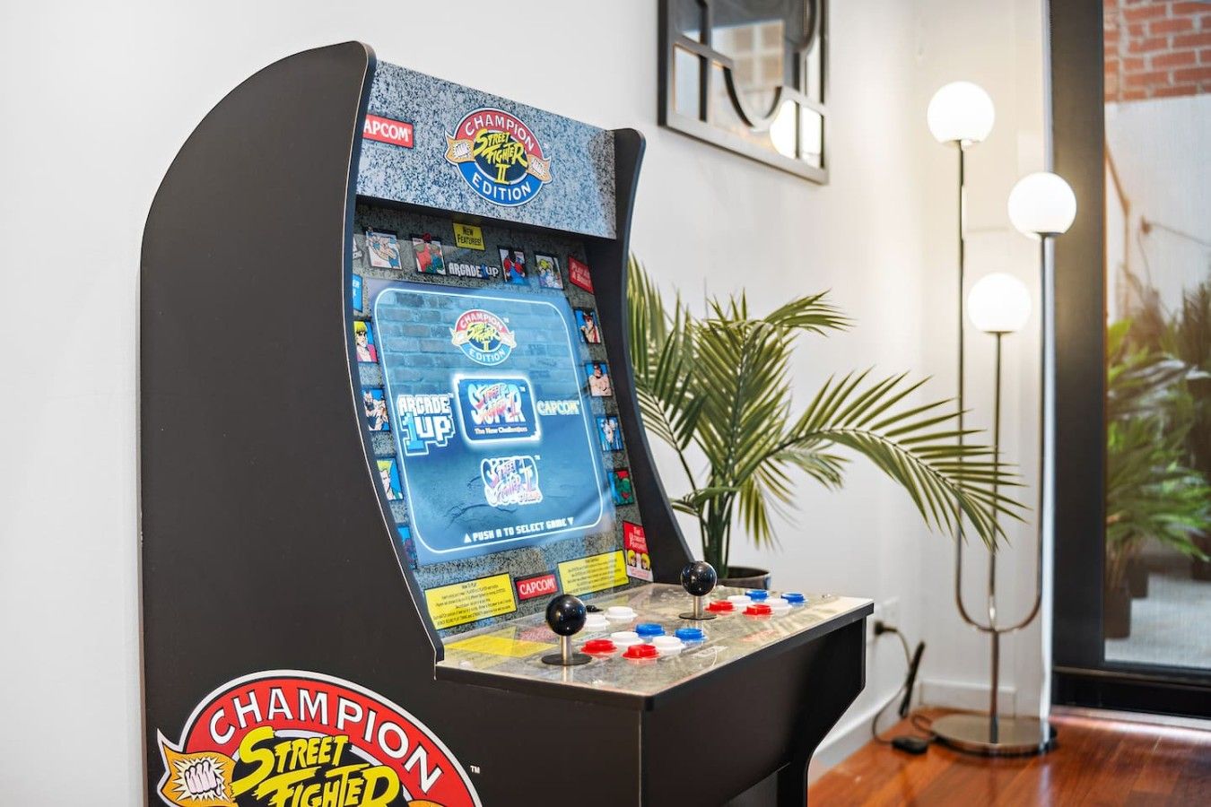 A retro arcade machine with a 'Champion Street Fighter II' label, featuring a joystick and button layout.