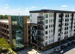 A multi-story hotel with a modern design, featuring balconies and large windows.